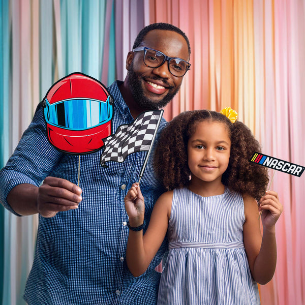 Father and daughter holding NASCAR photo booth props from Prime Party