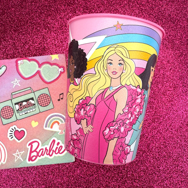 Add some sparkle to every sip with this fabulous Barbie plastic favor cup! Featuring Barbie in a glamorous pink gown with bold, confident style, and framed by a vibrant rainbow and starburst backdrop, this reusable cup is full of color, character, and fun. With a wraparound design showcasing a diverse cast of Barbie friends, it's perfect for party beverages or as a take-home favor filled with candy or small treats. Durable and lightweight, it’s a must-have addition to any Barbie-themed birthday bash or cele