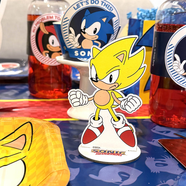 Sonic the Hedgehog figurine with drinks and promotional items on a table