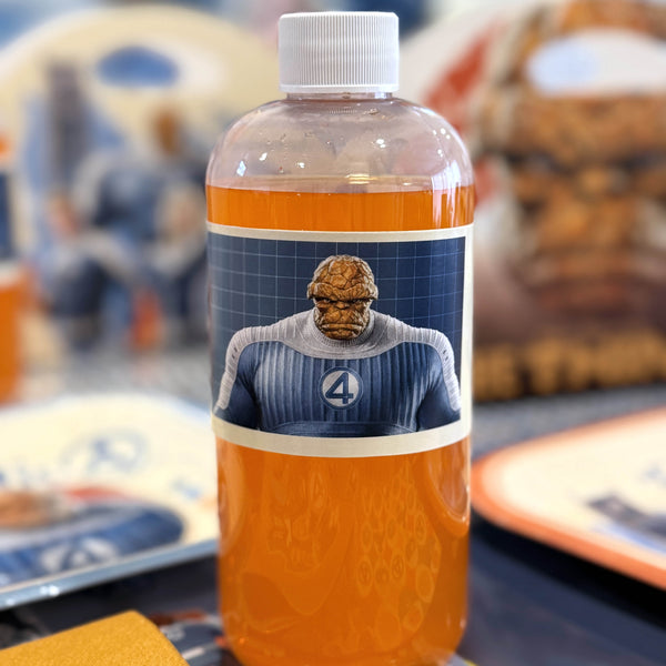 Bottle with a label featuring a character in a superhero costume on a colorful background