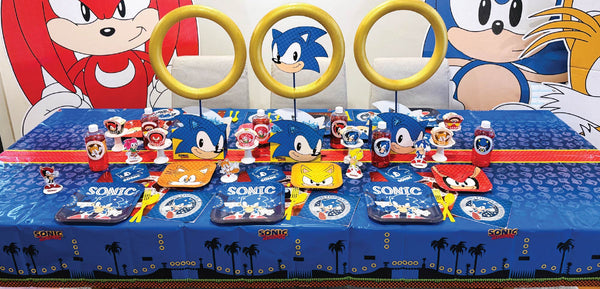 Classic Sonic party table setup with themed plates, napkins, banners, and bright blue and yellow décor.