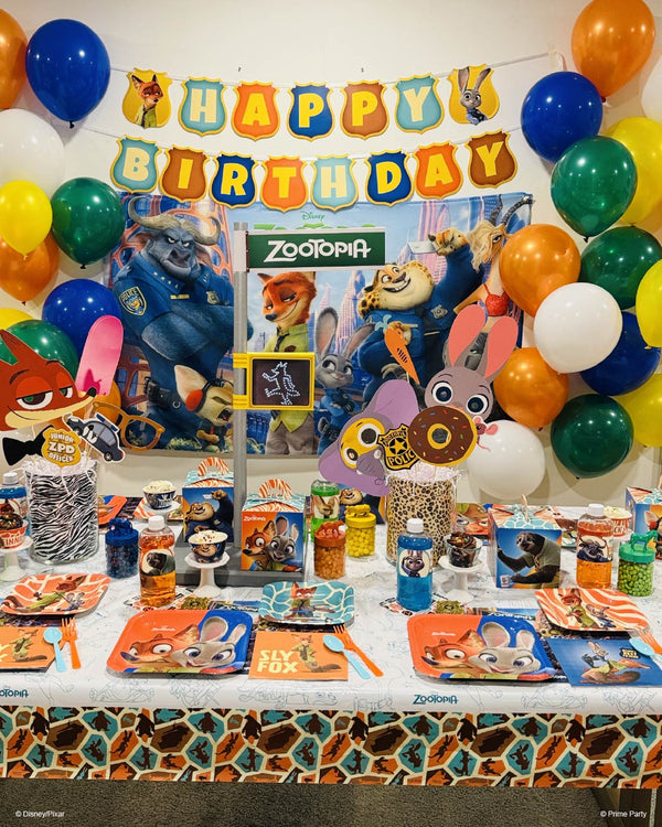 Zootopia party table fully decorated with balloons, banner, and tableware