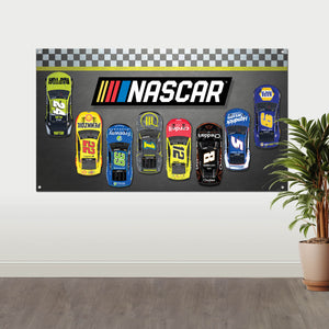The NASCAR Fabric wall banner by Prime Party, hanging on a wall with a plant in the foreground