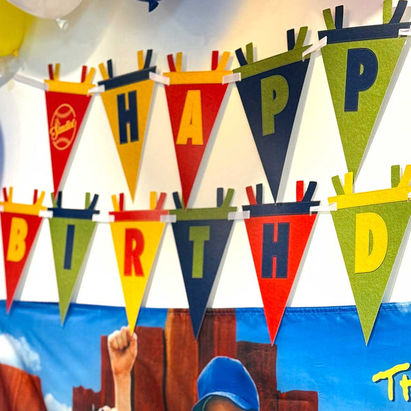 Children's birthday party with 'Happy Birthday' banner and 'The Sandlot' movie poster